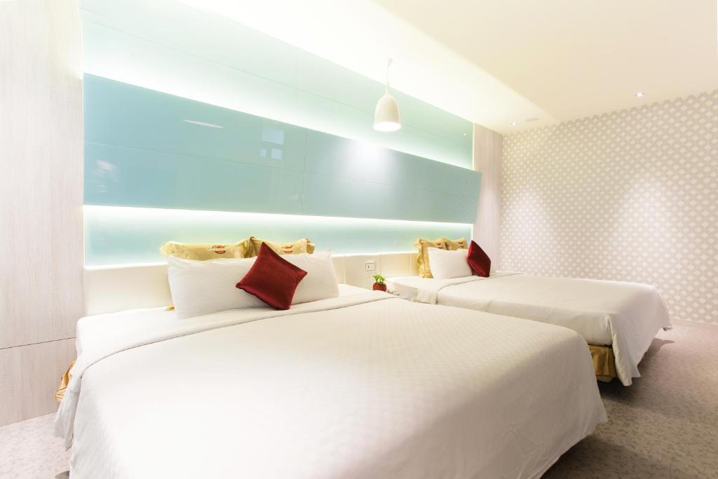 Postel nebo postele na pokoji v ubytování Six Star Motel-Zhongli