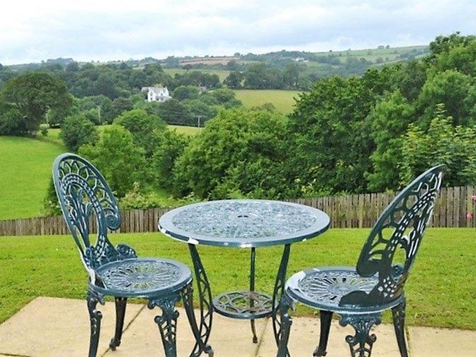 two chairs and a table with a table and two chairs at Meadowside Apartment in Fowey