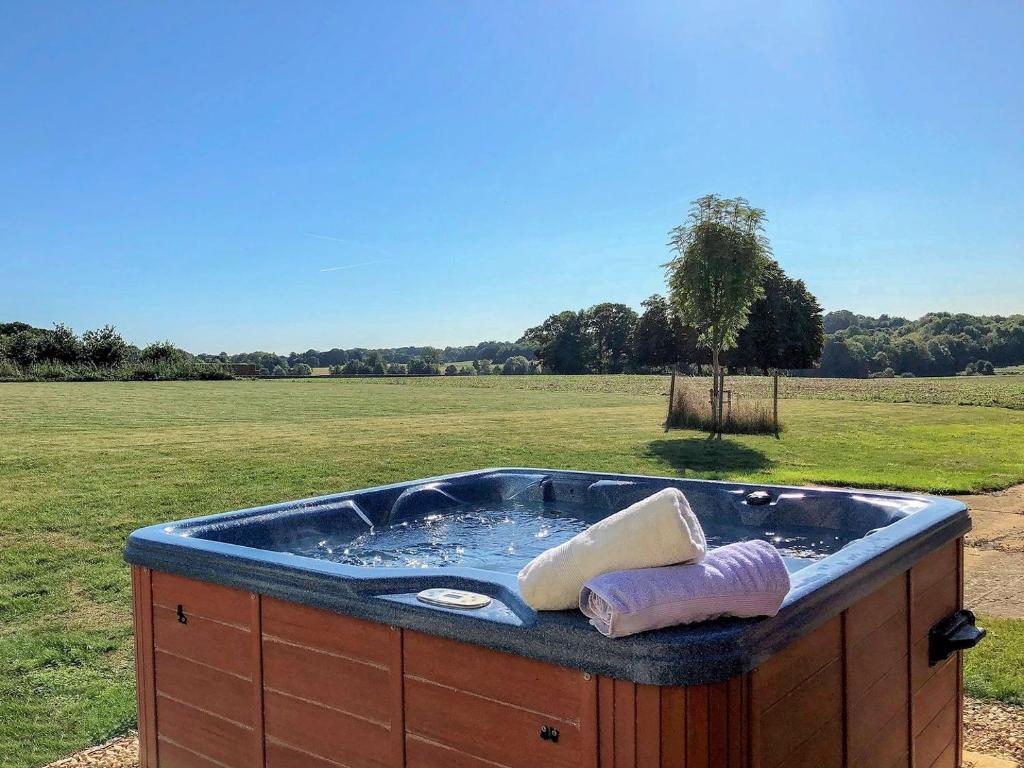 a hot tub in the middle of a field at The Stalls - Nac in Aynho