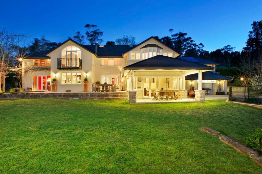 a large house with a green lawn in front of it at Ellengowan In Leura on 2 acres in Leura