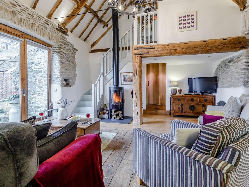 a living room with couches and a fireplace at The Threshing Barn - Hssw in East Down