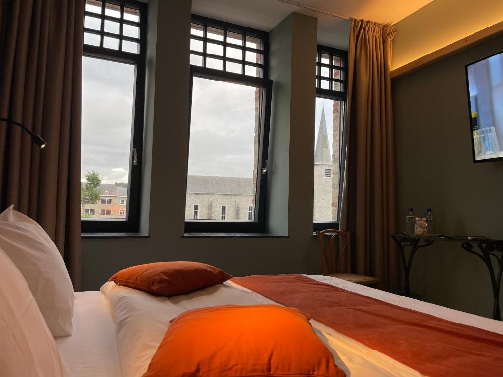 Postel nebo postele na pokoji v ubytování Hôtel Maison Demelenne