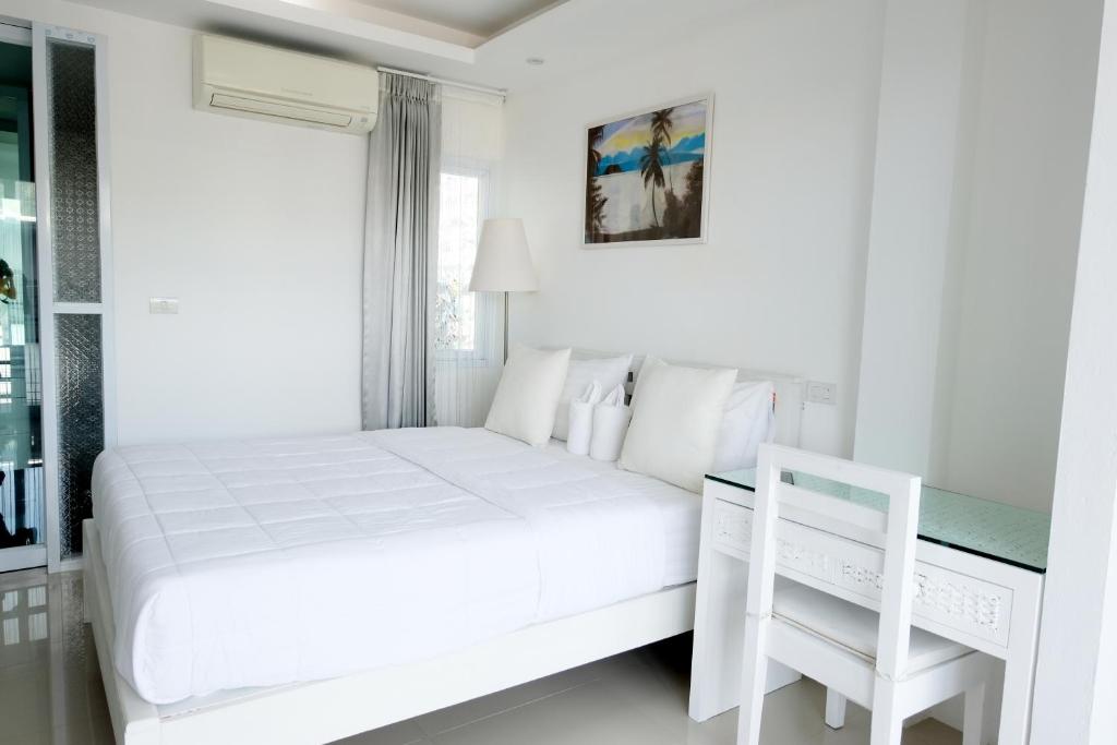Postel nebo postele na pokoji v ubytování Baanpoon Apartment