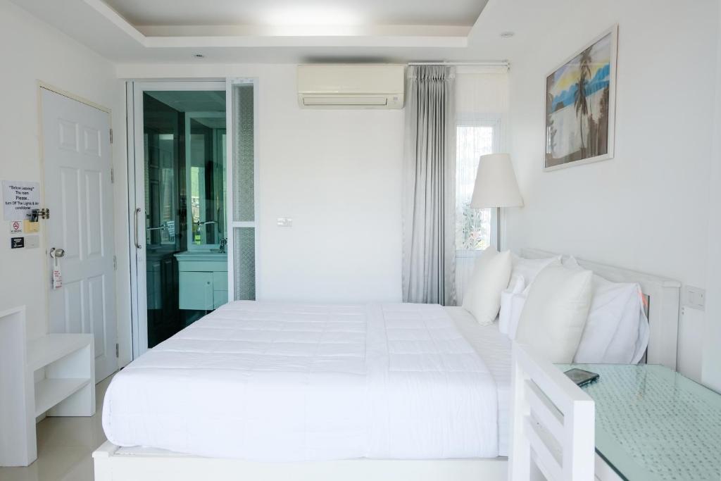 Postel nebo postele na pokoji v ubytování Baanpoon Apartment