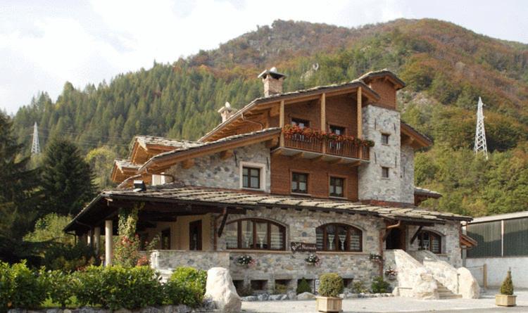 a large house with a balcony on top of it at Relais Del Nazionale in Vernante