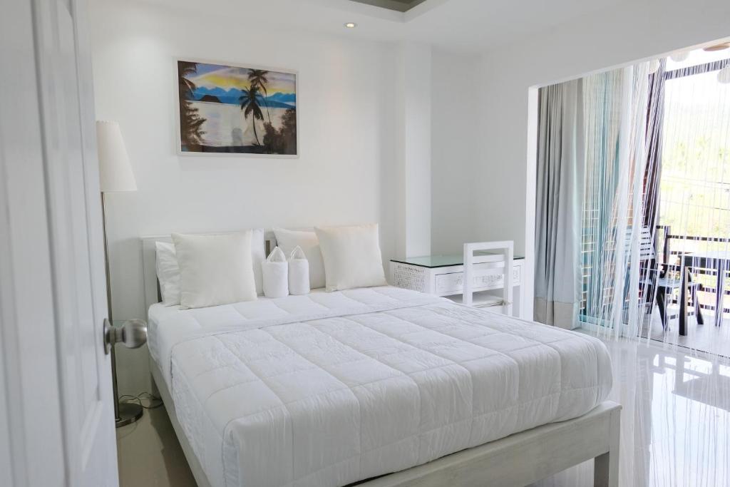 Postel nebo postele na pokoji v ubytování Baanpoon Apartment