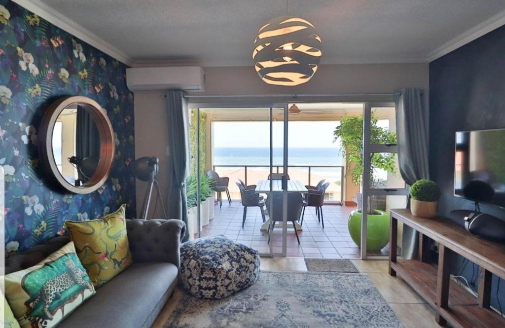 a living room with a couch and a view of the ocean at Lamer Holiday Apartment 66 in Kingsburgh
