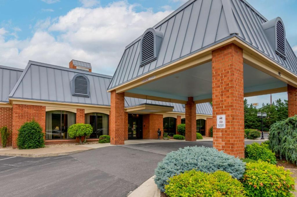 a large brick building with a metal roof at Best Western Staunton Inn in Staunton