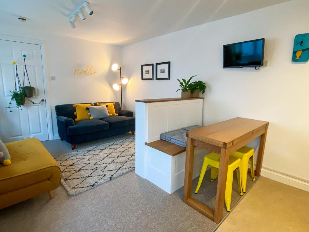 a living room with a table and a couch at The Garden Flat in Exmouth