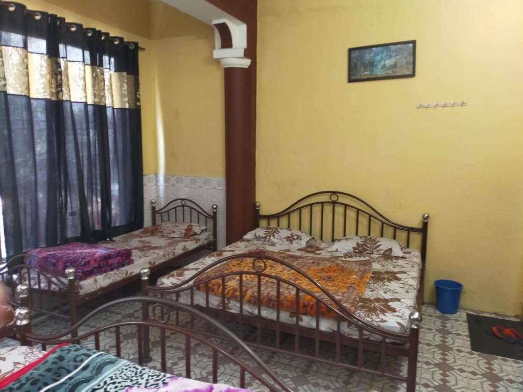 a room with two beds in a room with at Hotel Darpan By WB Inn in Jammu