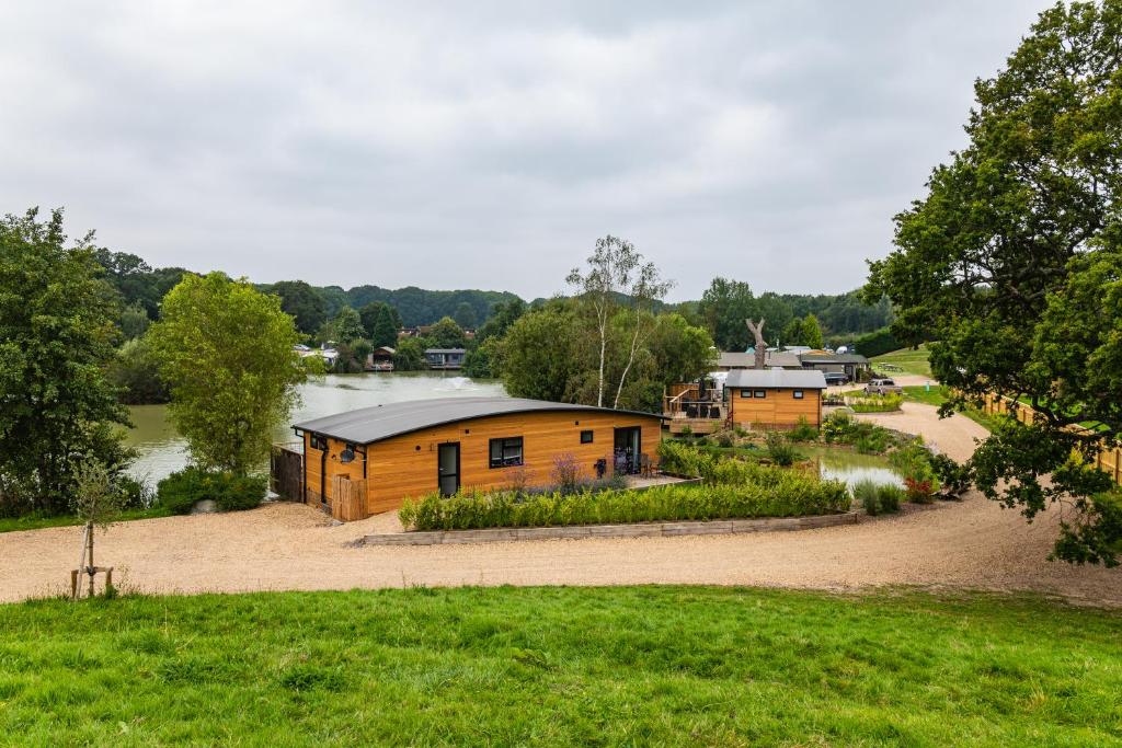 a group of cabins in a park with a grass field at Sumners Ponds Fishery & Campsite in Horsham