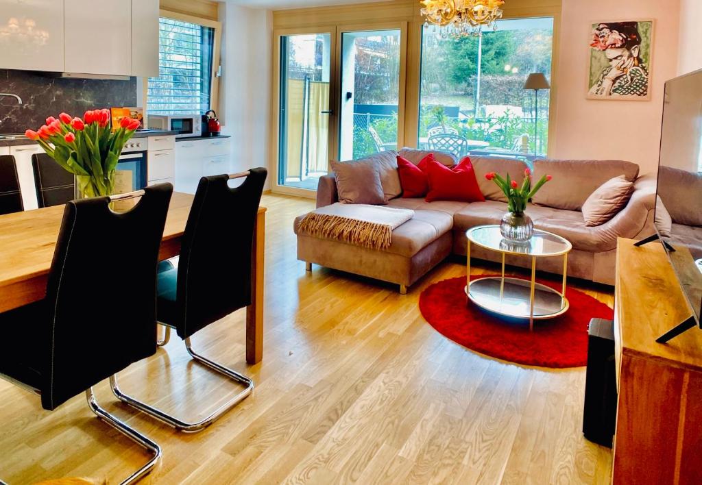 uma sala de estar com um sofá e uma mesa em Stilvolles Apartment «Coco» am Bodensee em Hörbranz