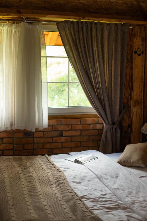 a bedroom with a bed and a window with curtains at Dolyna Mykolaya in Migovo