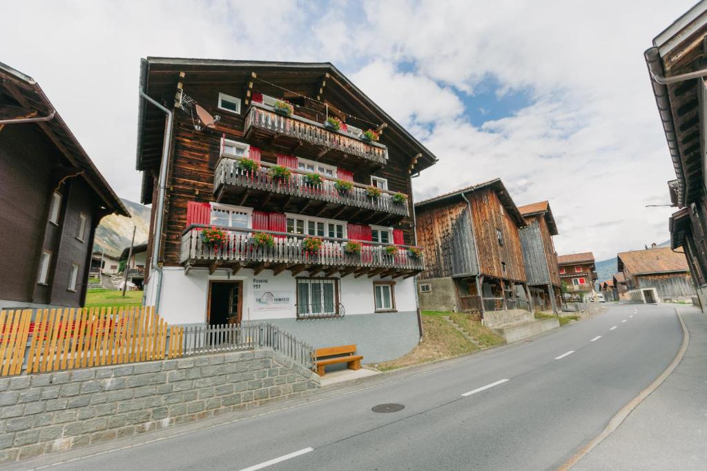a building with balconies on the side of a street at The Farmhouse in Sedrun