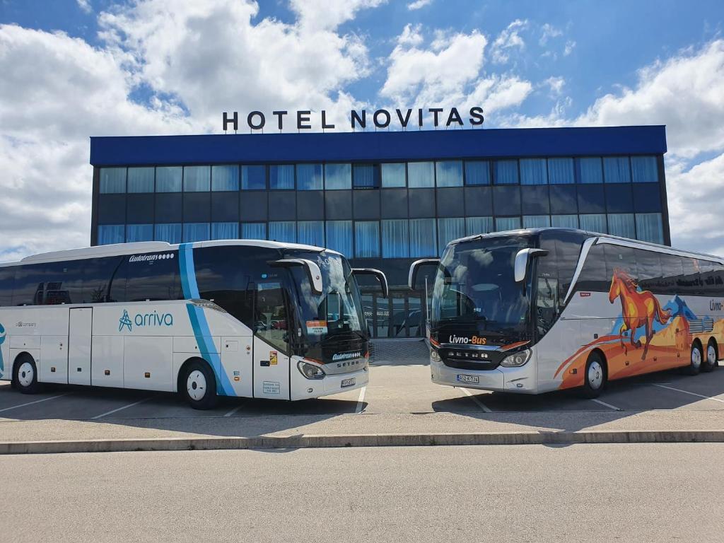 two buses are parked in front of a hotel nowadays at Hotel Novitas Livno in Livno