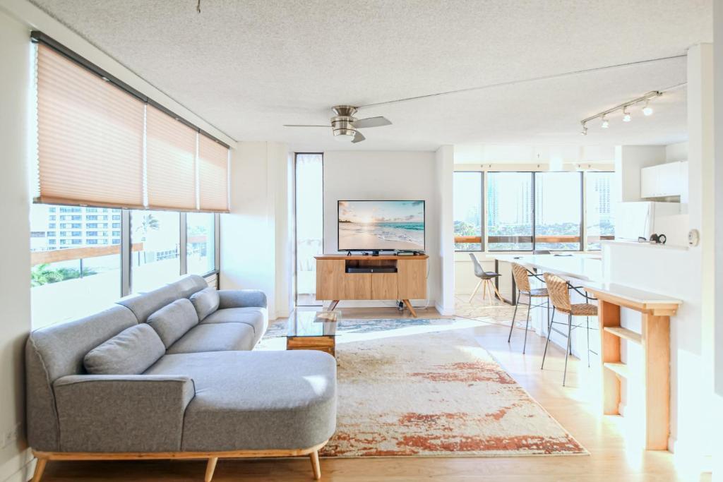 ein Wohnzimmer mit einem Sofa und einem Tisch in der Unterkunft Mid Century Modern Tropical Getaway 30 plus night rental in Honolulu