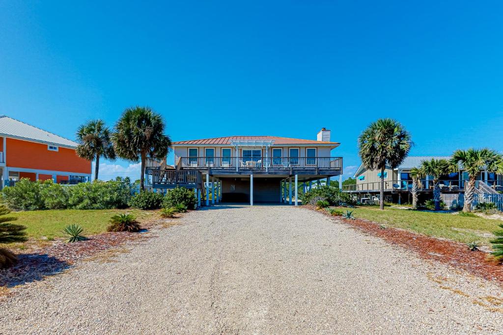 a large house with palm trees and a driveway at Island Charm in St. George Island