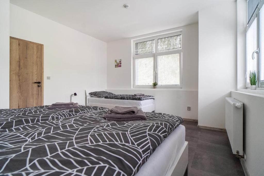 Postel nebo postele na pokoji v ubytování Apartmány U Jiříka