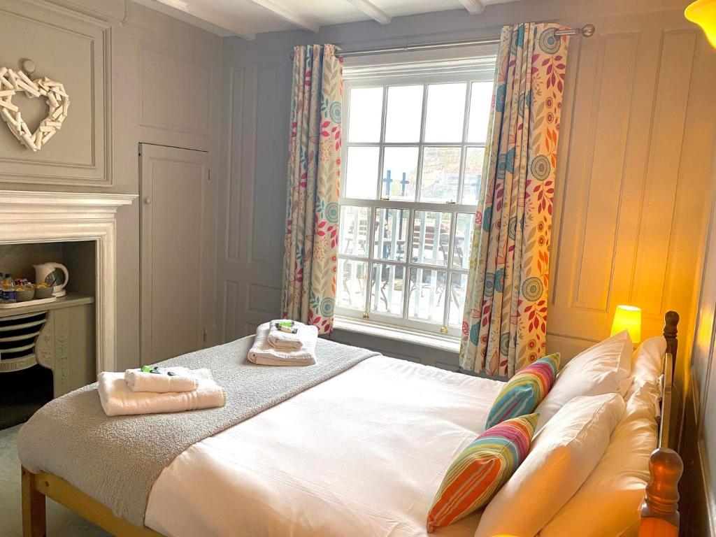 um quarto com uma cama com toalhas em The Pier Inn em Whitby