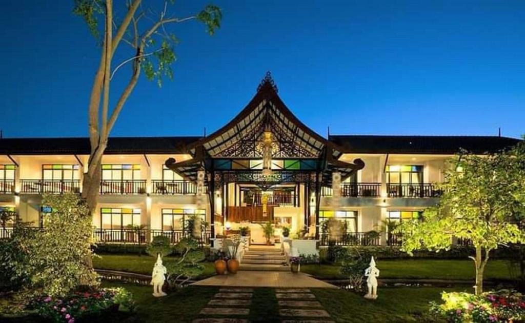 a large building with a gate in the yard at Radateeree Boutique Resort in Chiang Mai