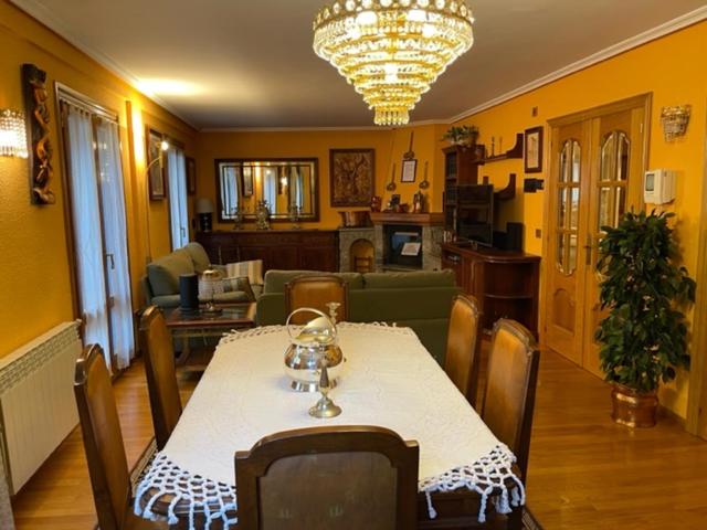 a dining room with a table and a living room at Casa Conchita de Benasque in Benasque