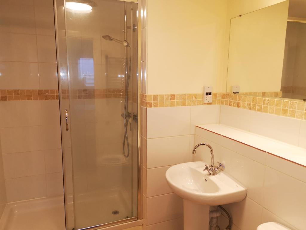 a bathroom with a shower and a sink at City Centre Penthouse in Southampton