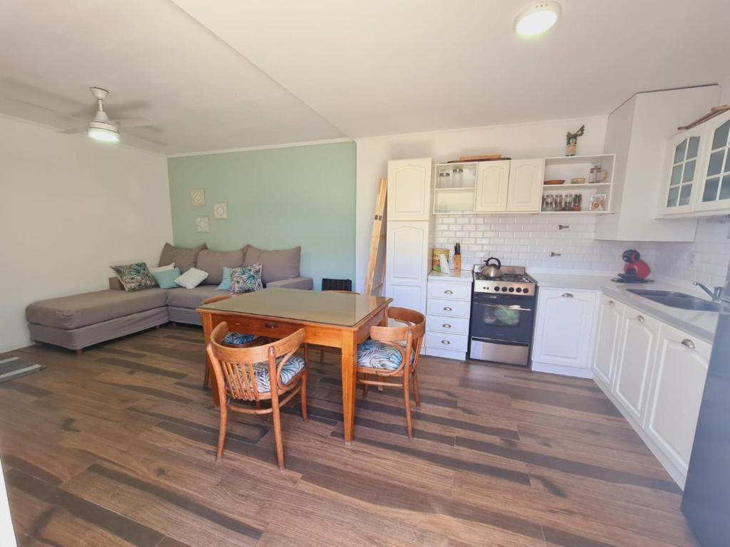 a kitchen and living room with a table and chairs at Apart Esperanza in Esperanza