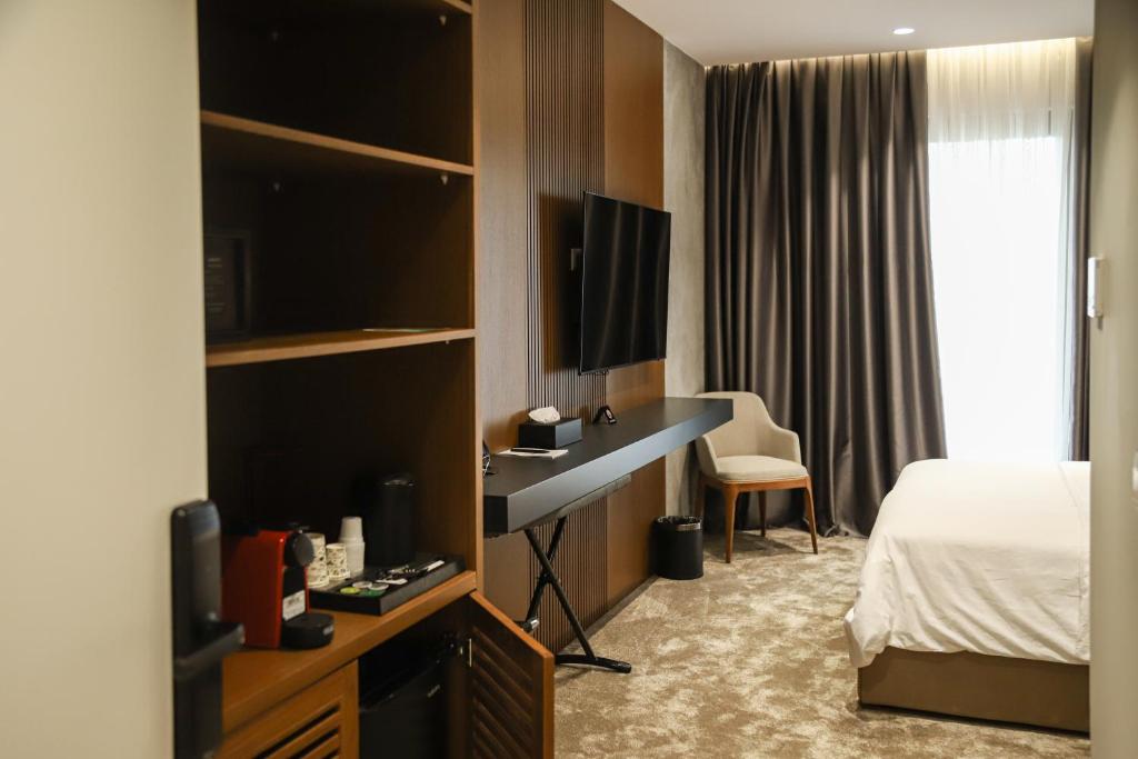 Postel nebo postele na pokoji v ubytování Urbanin Apartment & Hotel