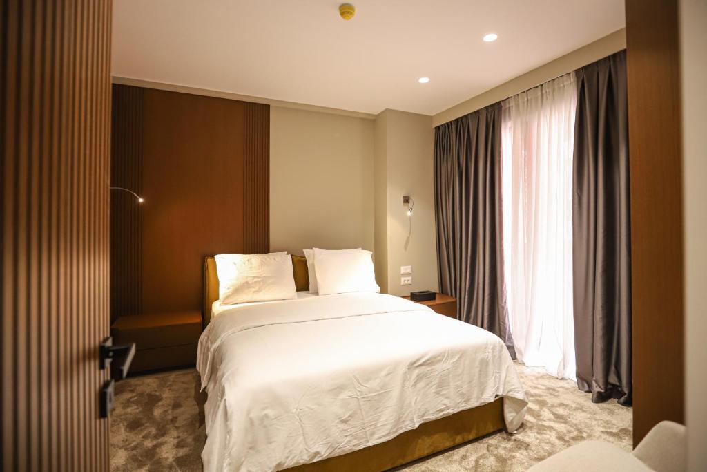 Postel nebo postele na pokoji v ubytování Urbanin Apartment & Hotel