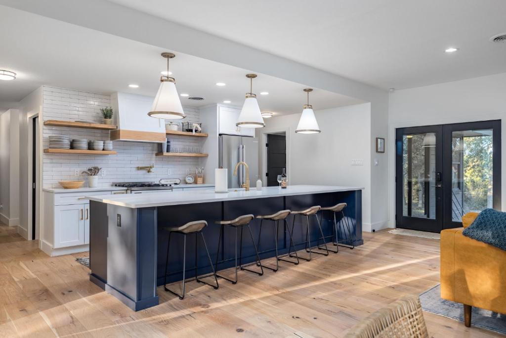 a kitchen with a large blue island with bar stools at Amazing Modern Farmhouse Retreat w/ 2 Suites in Canyon Lake