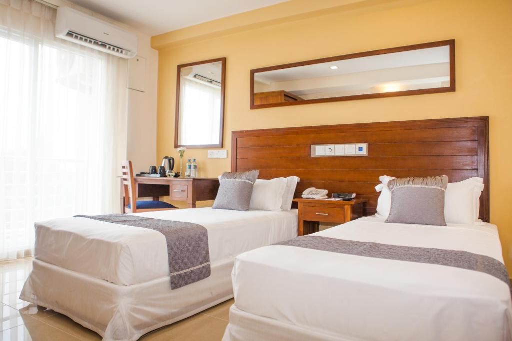 Postel nebo postele na pokoji v ubytování GSH Colombo