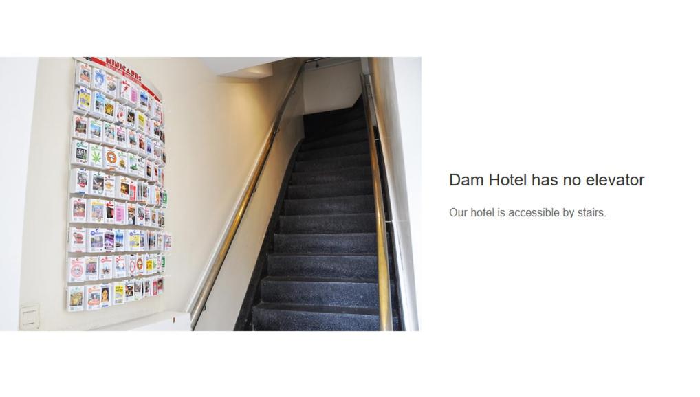 a staircase in a building with a sign that reads exam inside has no elevator at Dam Hotel in Amsterdam