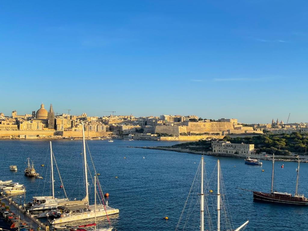 a view of a harbor with boats in the water at Seafront Duplex Penthouse in Sliema