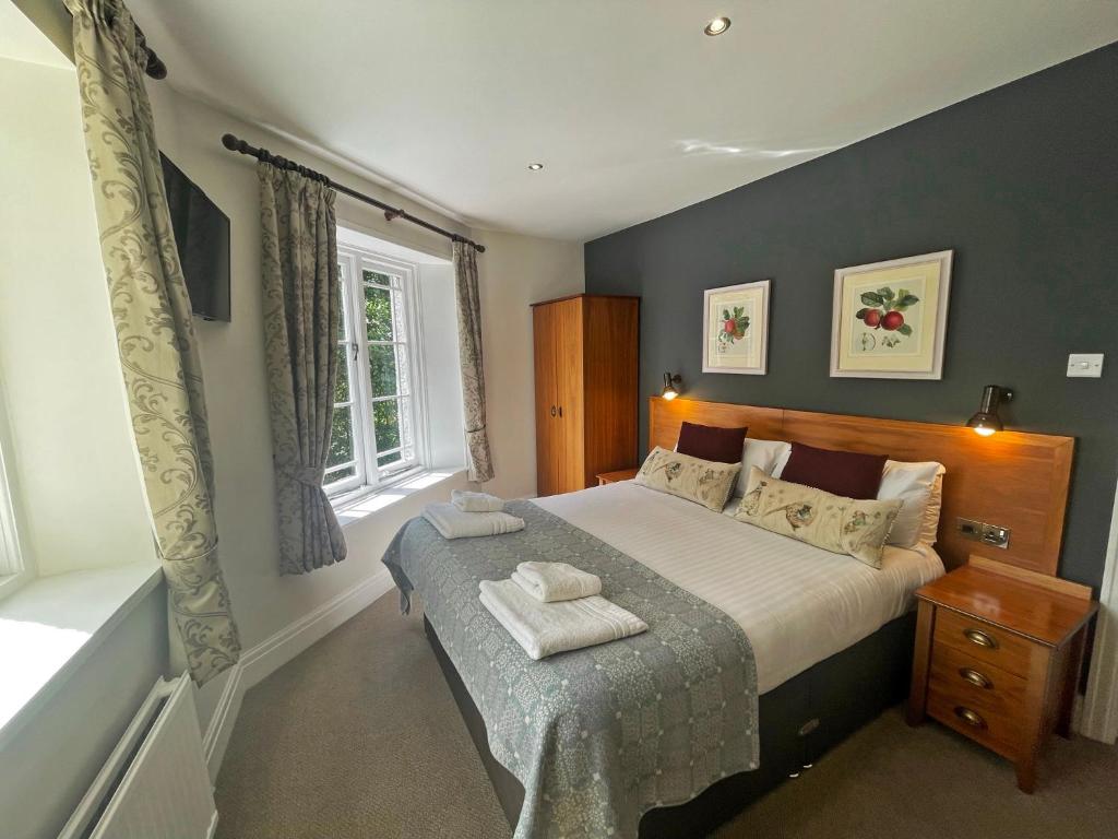 a bedroom with a large bed and a window at The Jug And Bottle in Heswall