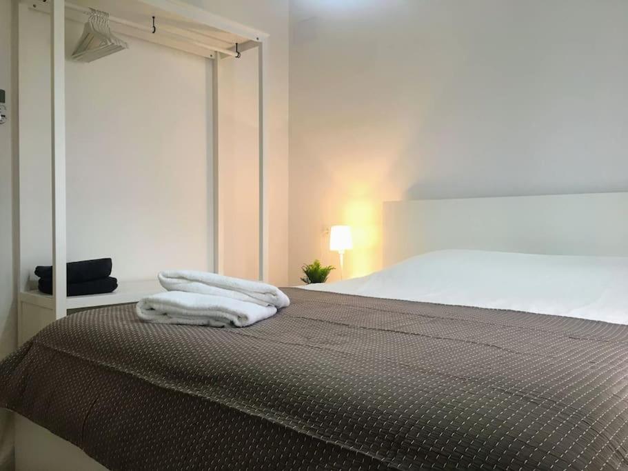 a bedroom with a bed with two towels on it at NEW! Renovated house with terrace in Cambrils in Cambrils