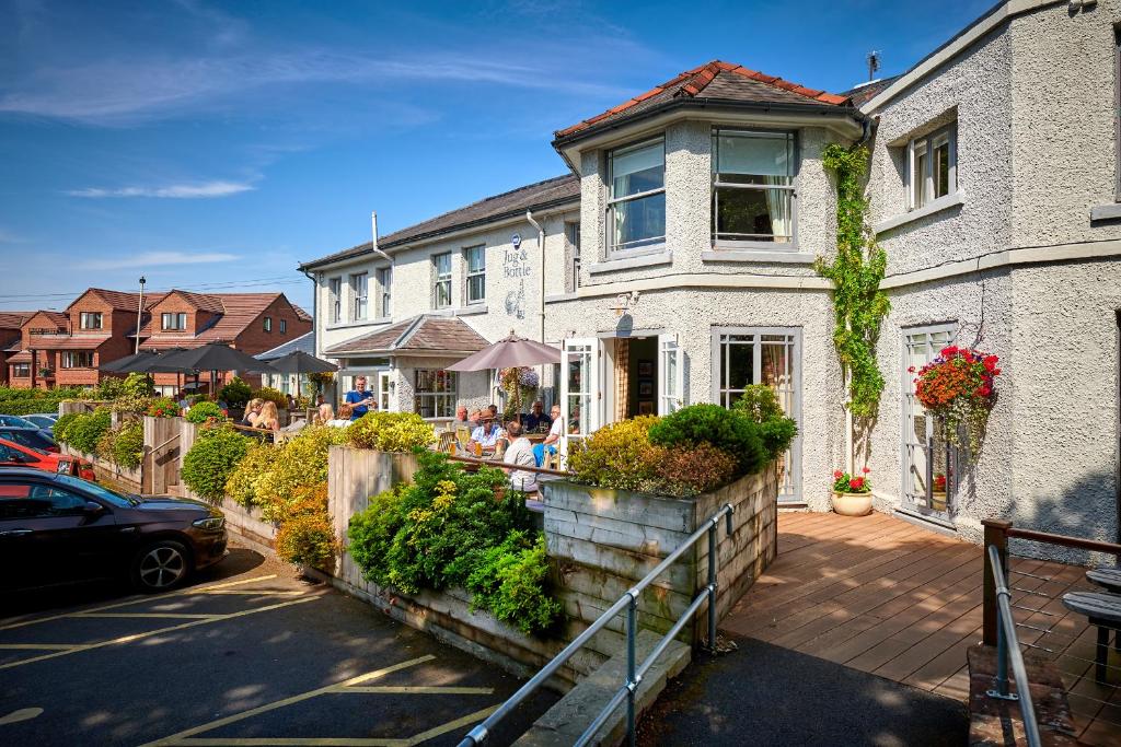 a house with people sitting outside of it at The Jug And Bottle in Heswall