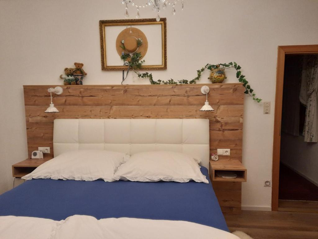 a bedroom with a bed with a wooden headboard at Chalet Damtschach in Damtschach