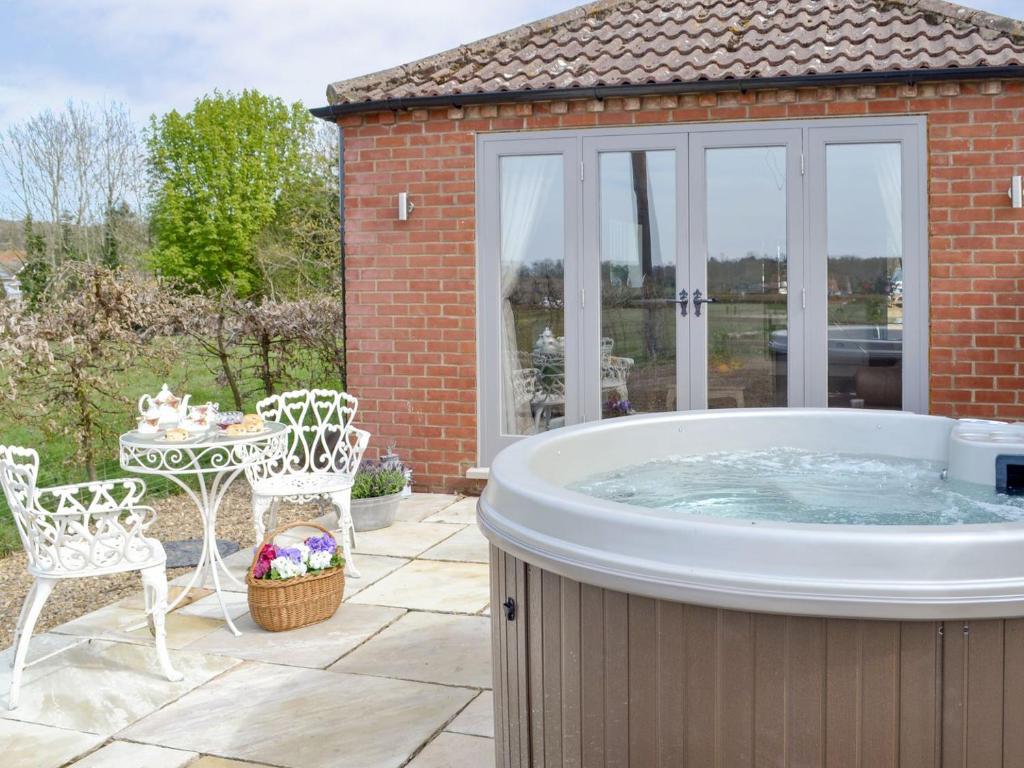 a hot tub in the backyard of a house at Hares Home - Uk10757 in Barney