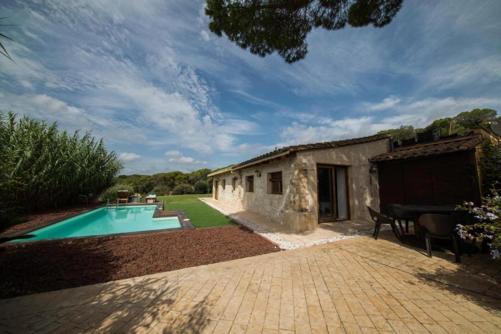 a house with a swimming pool in a yard at The calm house in Santa Cristina d'Aro