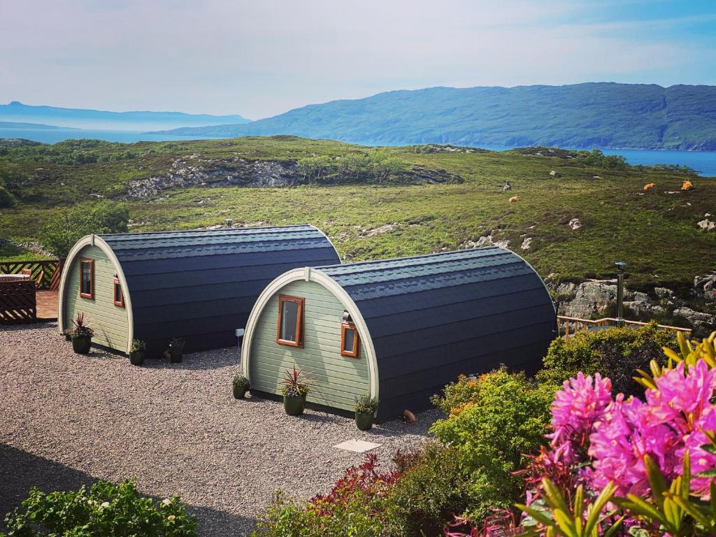 a house with a solar panel on top of a hill at Duirinish Pods with Private Hot Tubs and Duirinish Bothy with No Hot Tub in Plockton