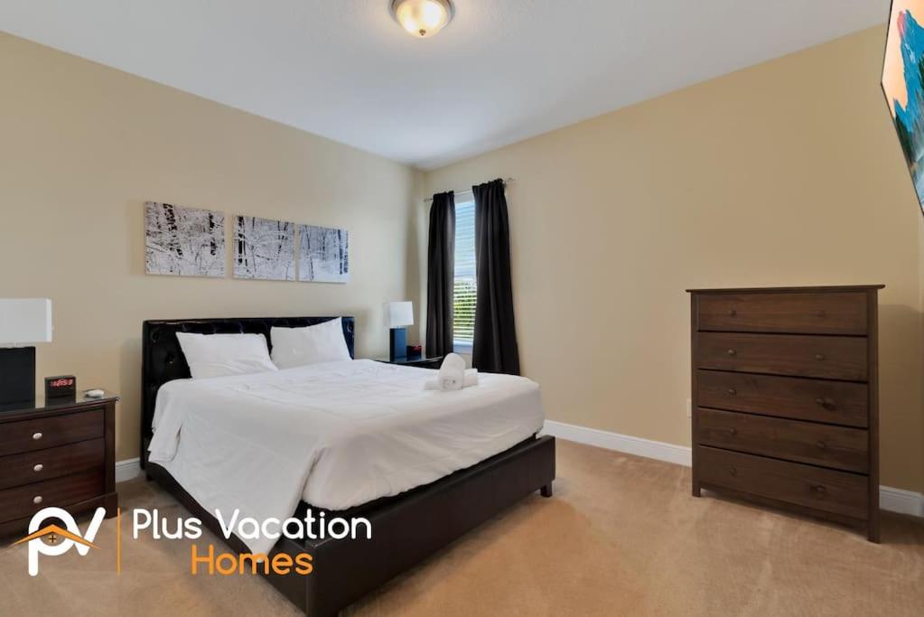 a bedroom with a large bed and a dresser at 371-Luxury Villa with POOL in Orlando