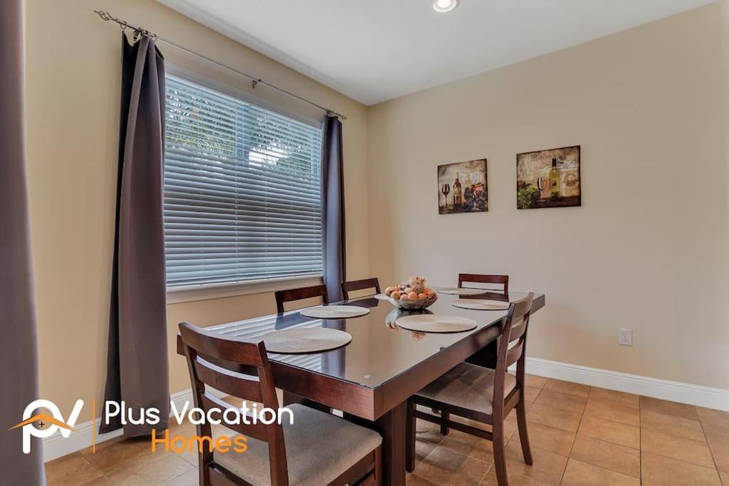 a dining room with a table and chairs and a window at 371-Luxury Villa with POOL in Orlando