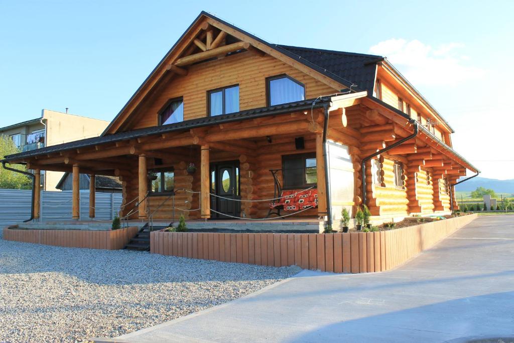 a large wooden cabin with a gambrel roof at Liptovsky Zrub in Gôtovany