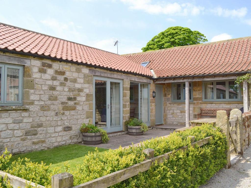 a stone house with a red roof at Riccal Heads in Lastingham