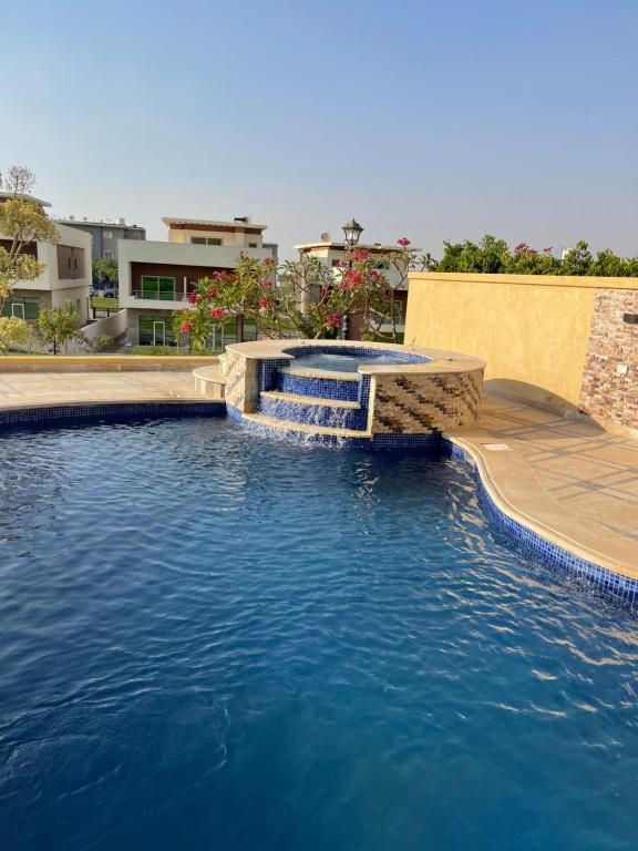 a swimming pool with a fountain in the middle at Awesome Villa on a hill Families only in Cairo