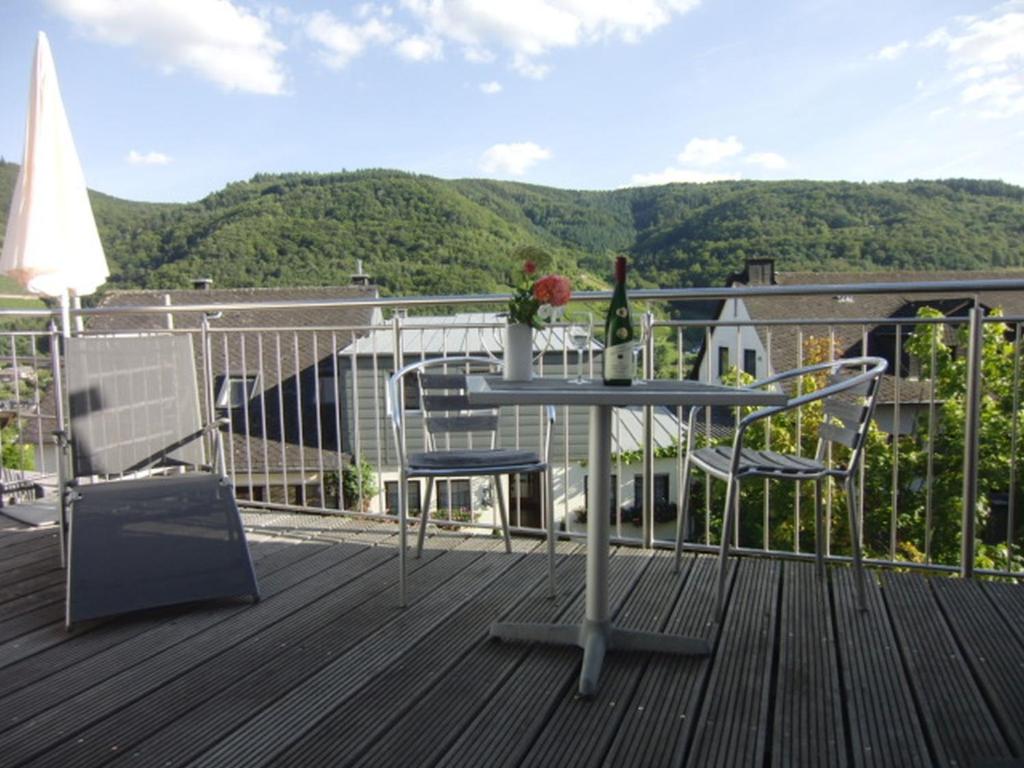a table and two chairs on a deck with a view at Am Weinberg in Bernkastel-Kues