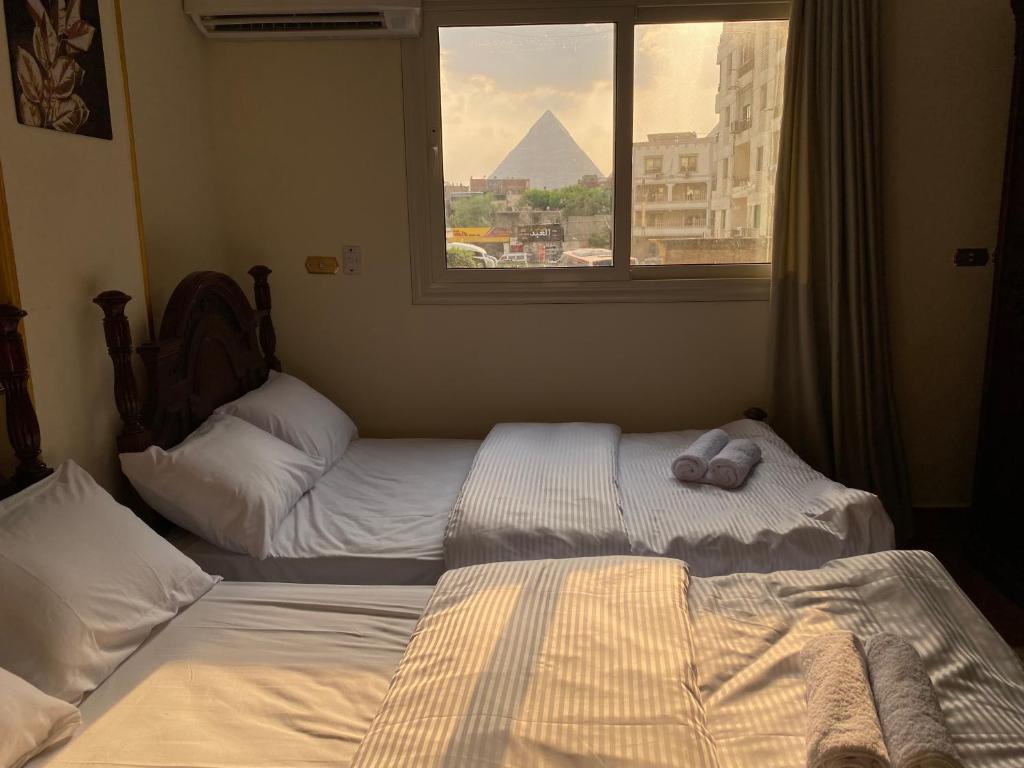 Voodi või voodid majutusasutuse Asma Pyramids View toas