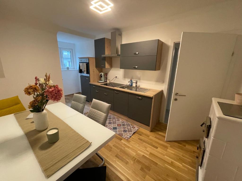 a kitchen with a table and a counter top at LevelUp 2 Living Graz m. SelfCheckIn in Graz