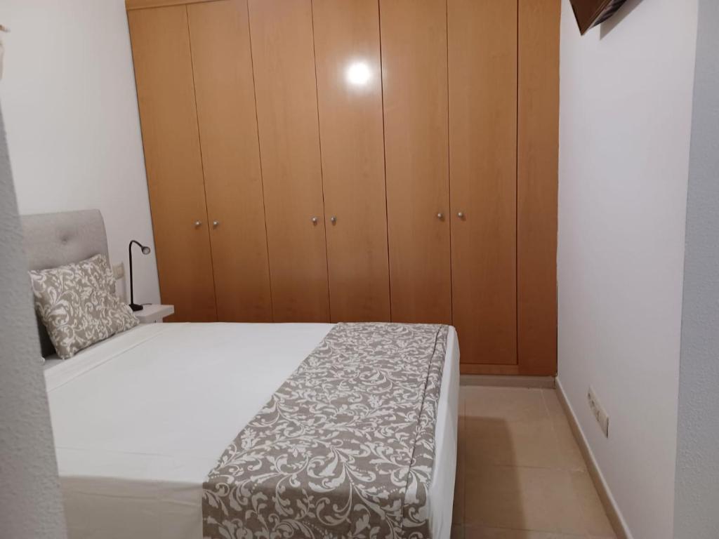 A bed or beds in a room at For You Rentals TEMPORAL Infantas Gran Via INF2E