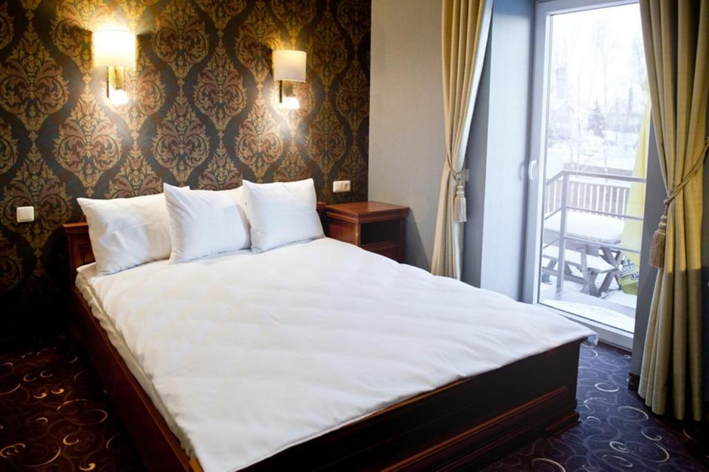 מיטה או מיטות בחדר ב-Pas Radvila